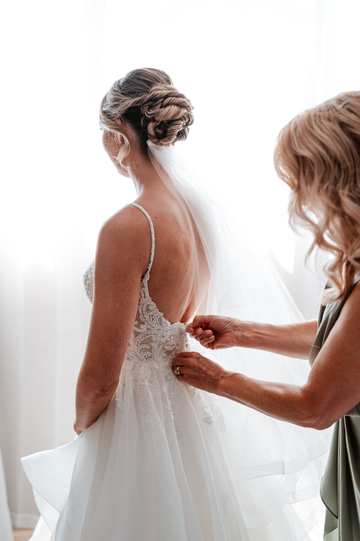 Emily getting her wedding dress perfectly ready for her wedding ceremony