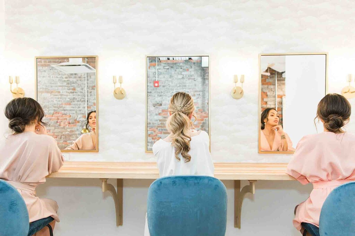 Bride and bridesmaids getting ready in bridal suite at Venue 308, a historical warehouse wedding venue in Calgary, featured on the Brontë Bride Vendor Guide.