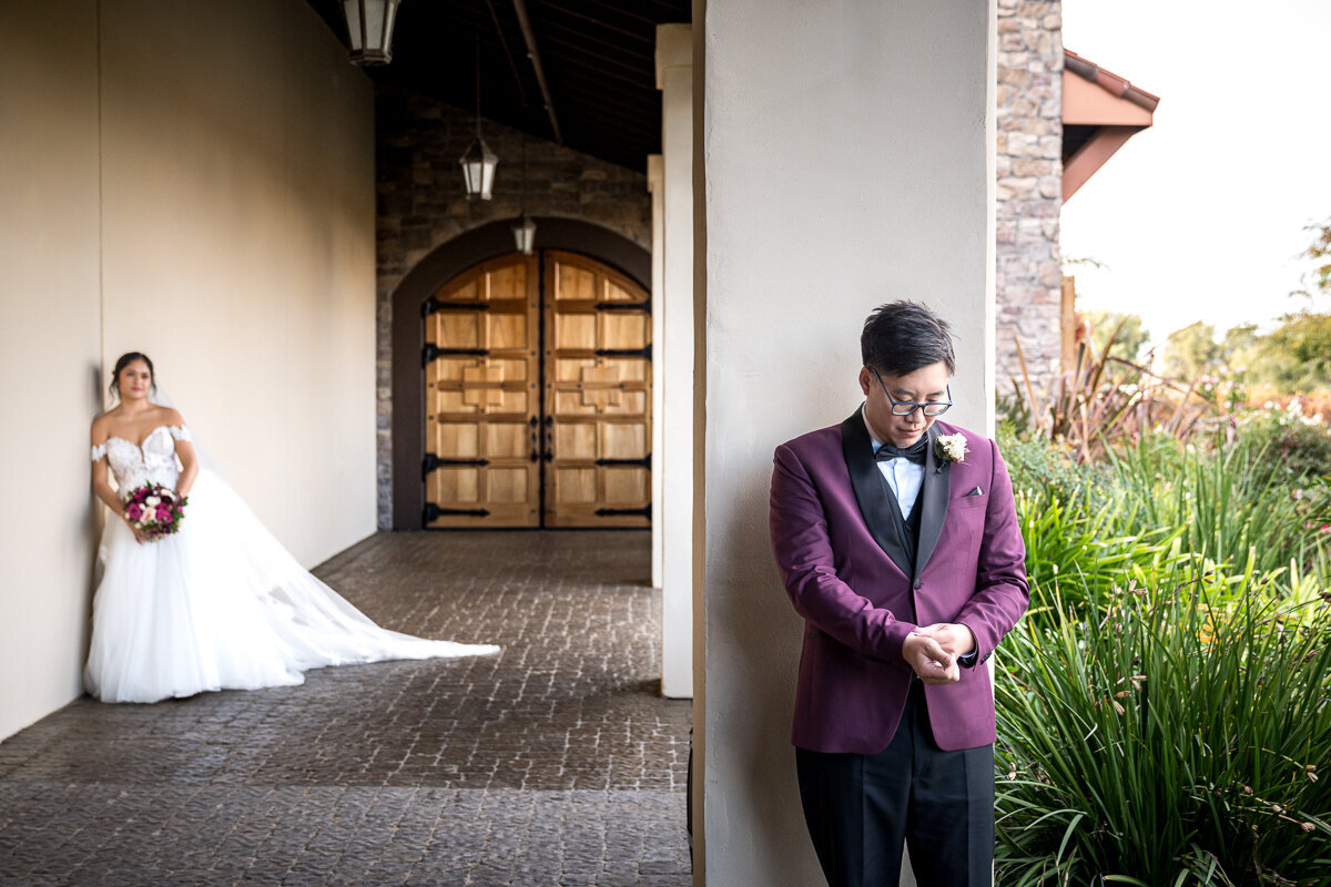 A heartfelt moment between bride and groom in front of a gorgeous door at Ruby Hill Winery. Capturing the romance of a Pleasanton wedding venue.