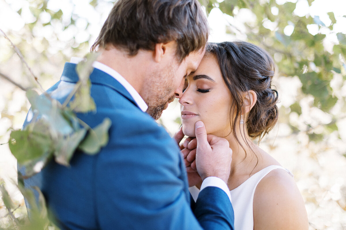 intimate moment between bride and groom  resting with their foreheads together