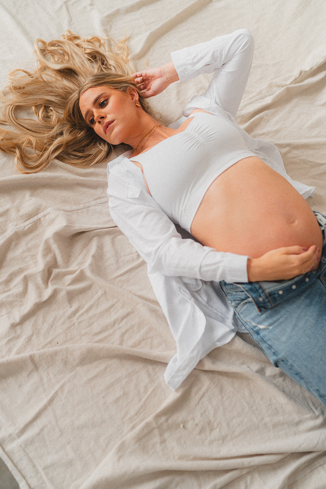 A pregnant woman lays on the ground