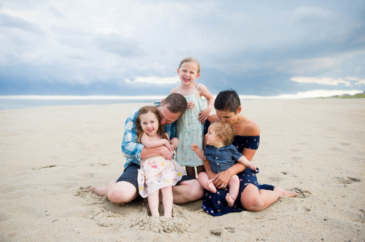 fun family on beach with stormy skies
