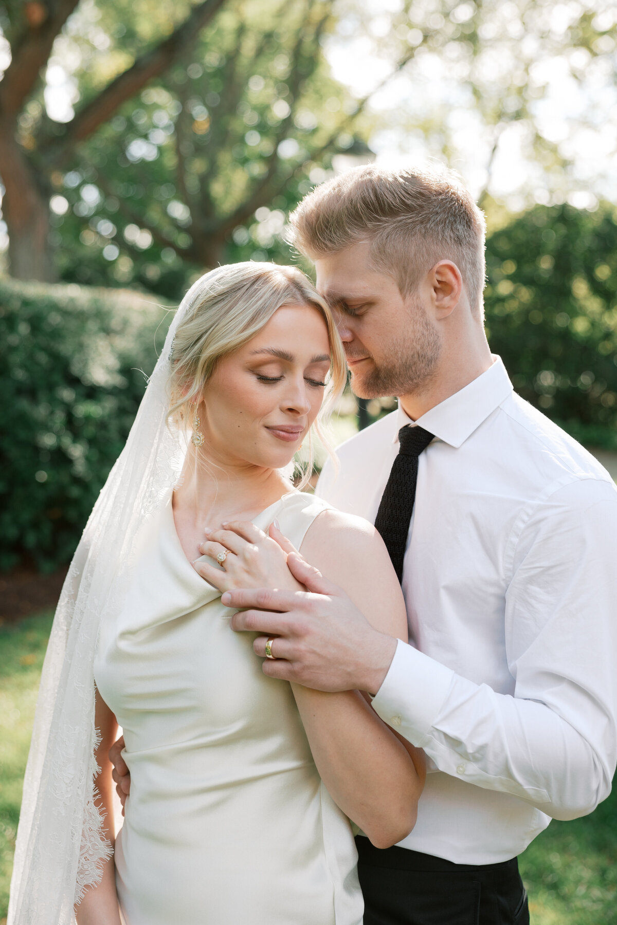 Close-up of bride and groom in embrace at their Dayton, Ohio wedding, by a Philadelphia wedding photographer.