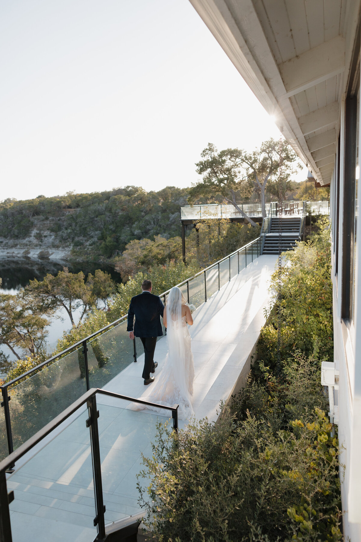 A couple walking across the bridge at the Videre Estate.
