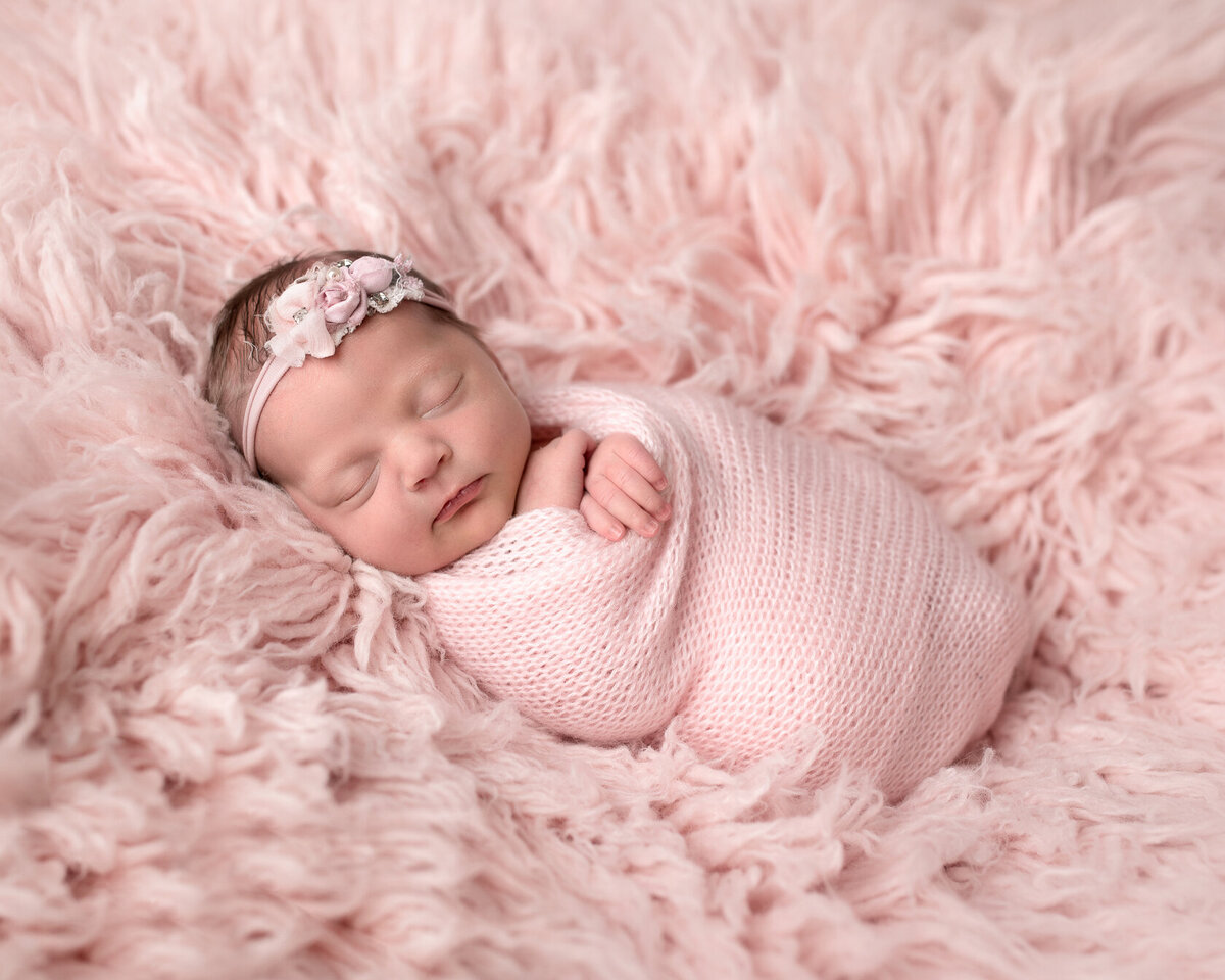 Cute little baby in pink fur by Houston Photographer