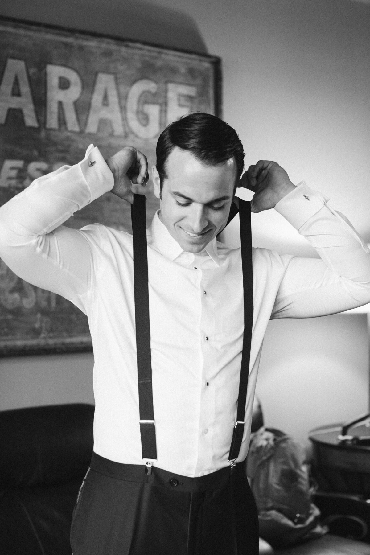 groom-pulling-suspenders