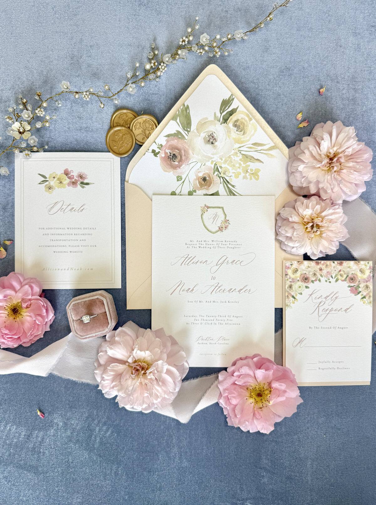 Floral wedding invitation suite, with watercolor floral details, envelope liner, blush envelopes, silk ribbon, and wax seals. 