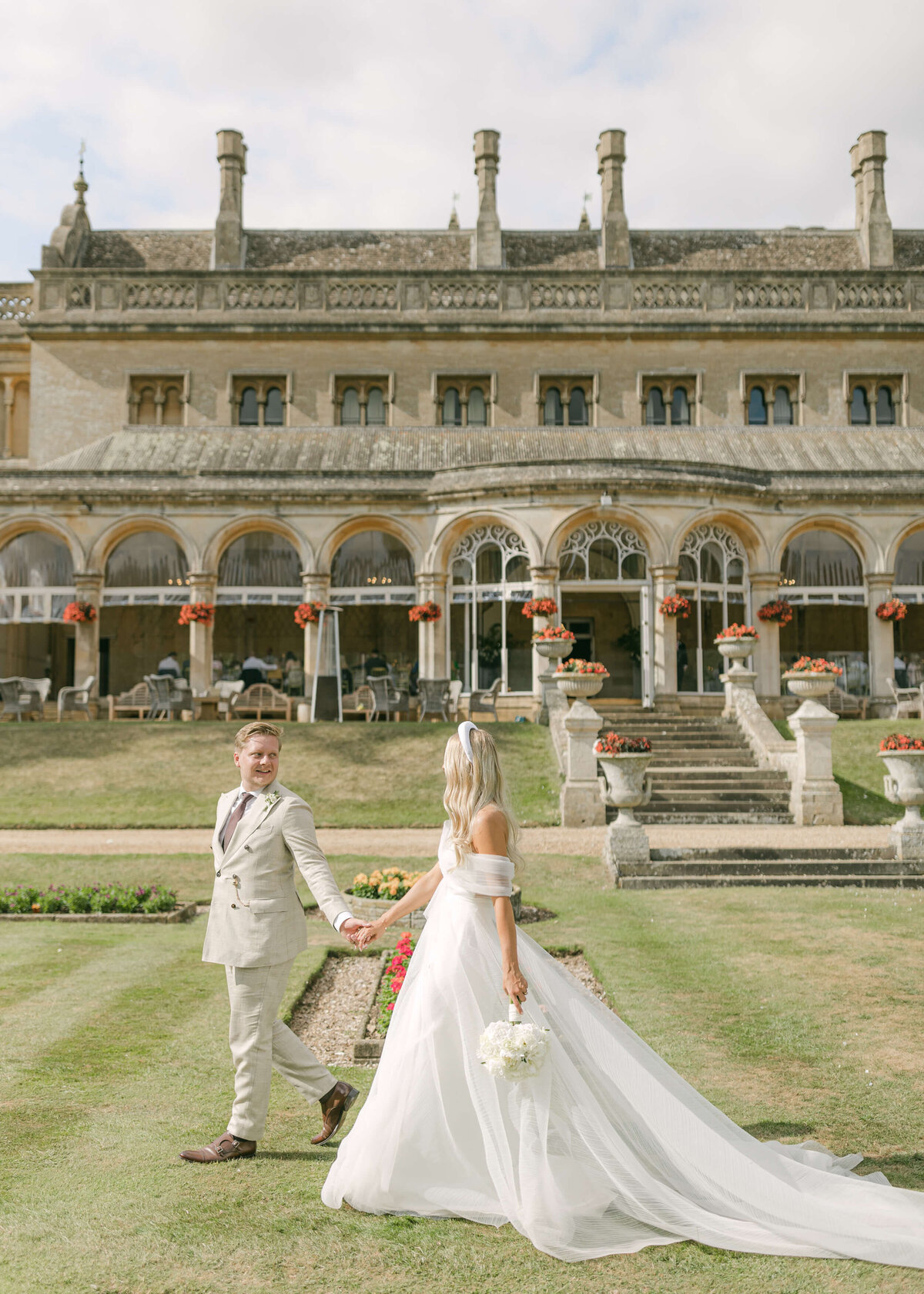 chloe-winstanley-weddings-grittleton-house-gardens-conservatory-bride-groom-walking