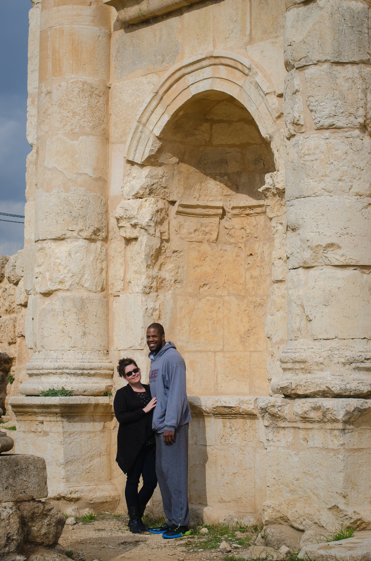 Jill and Desmond Blue standing in an arch at the Roman ruins of Jaresh, Jordan