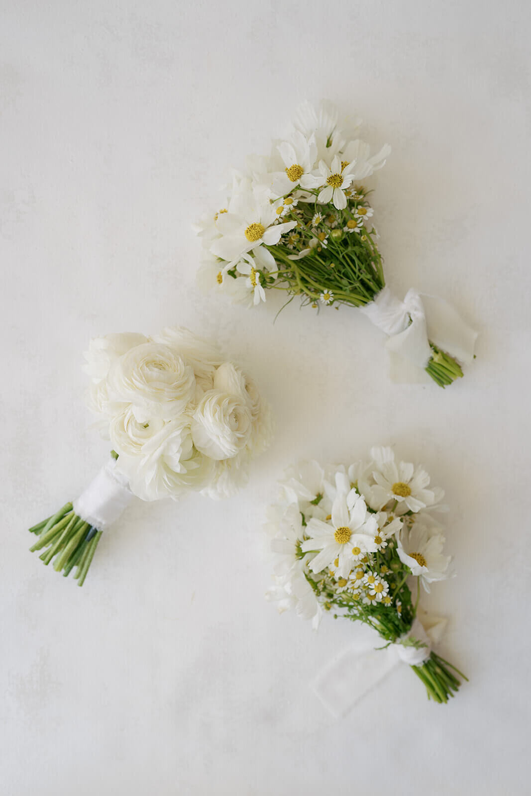 Wedding bouquets featuring white seasonal flowers on a clean white background at the Aspen Meadows Resort Wedding.