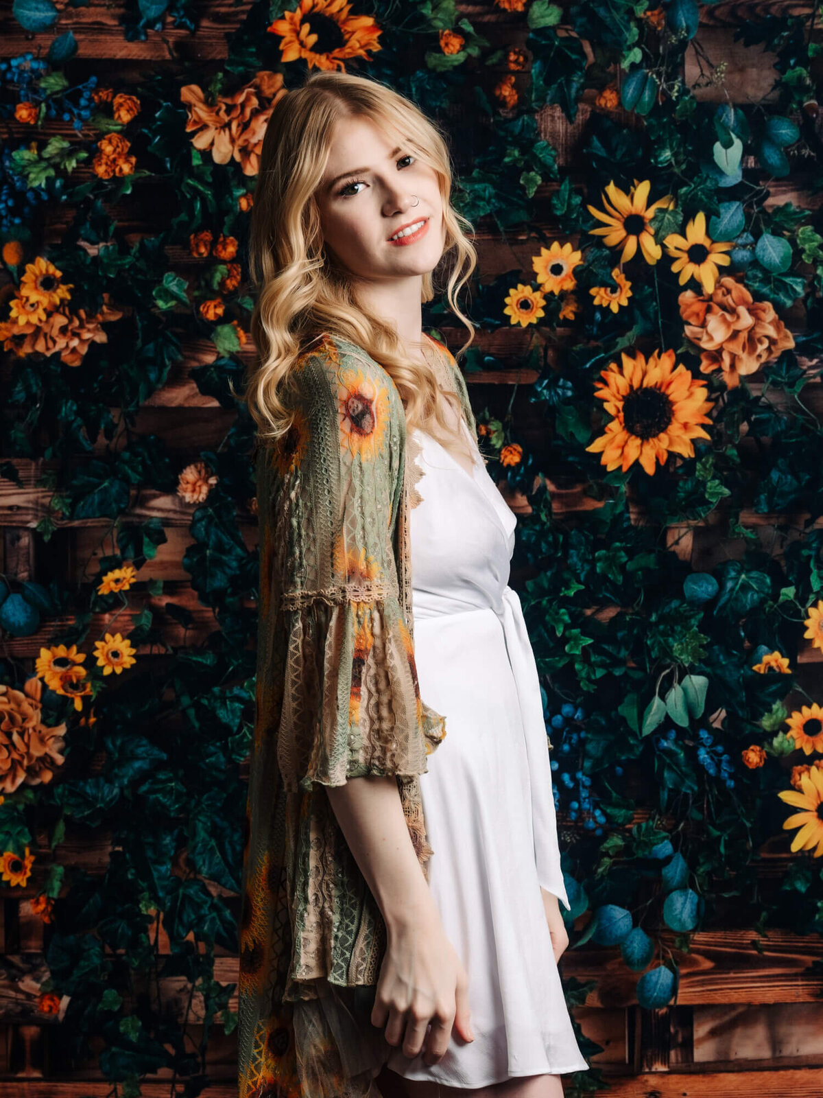 Girl poses in front of sunflowers for Prescott senior photographer Melissa Byrne