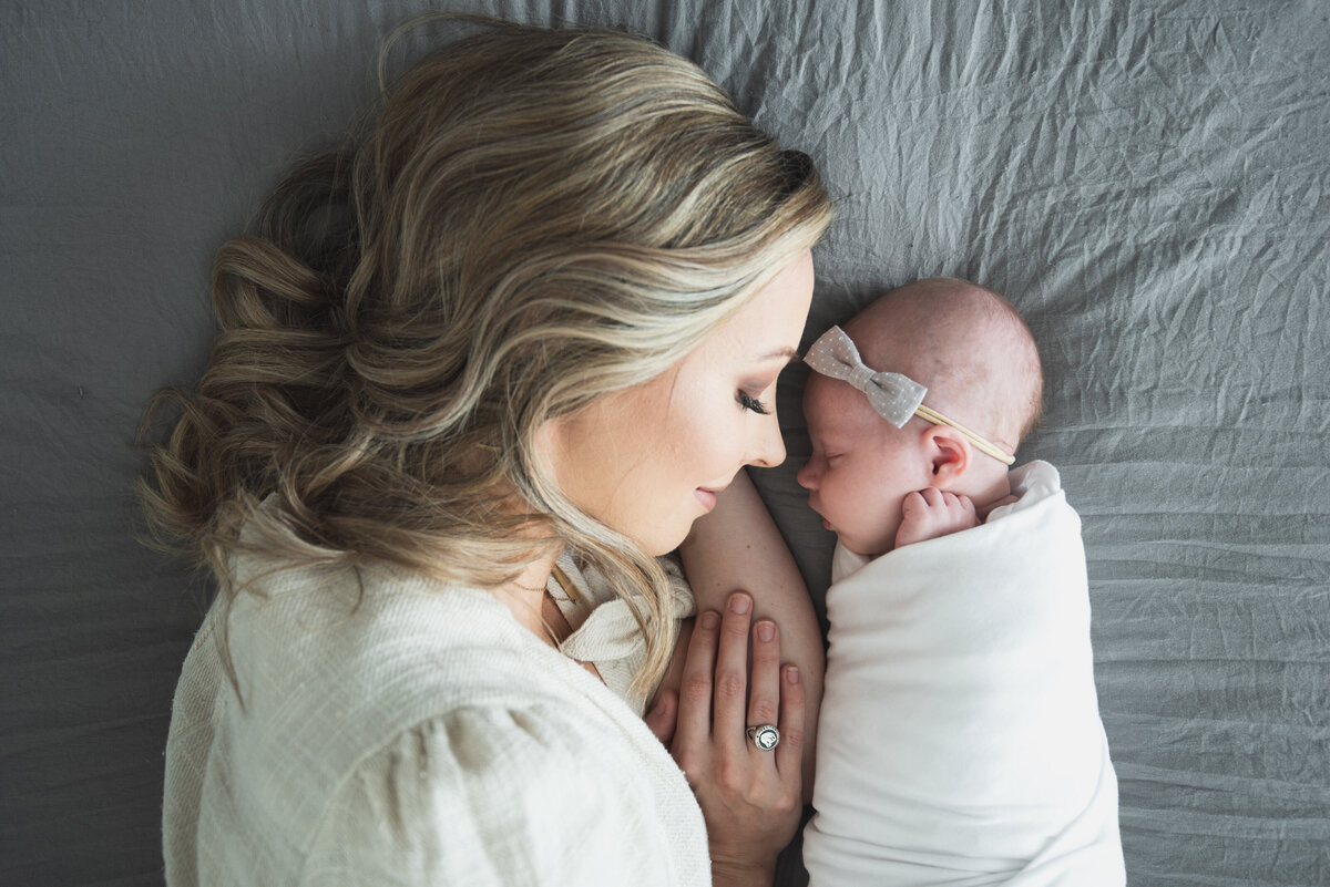 Mom laying down with baby during the lifestyle newborn session