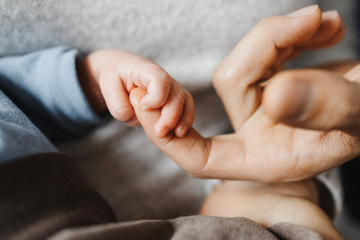 Baby hält Hand vom Vater