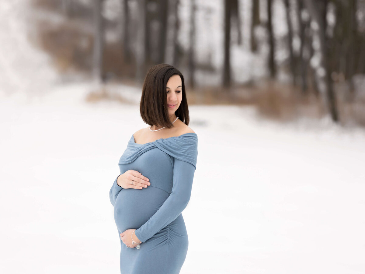 Maternity portrait by an Erie Pa photographer in the snow in Clymer NY