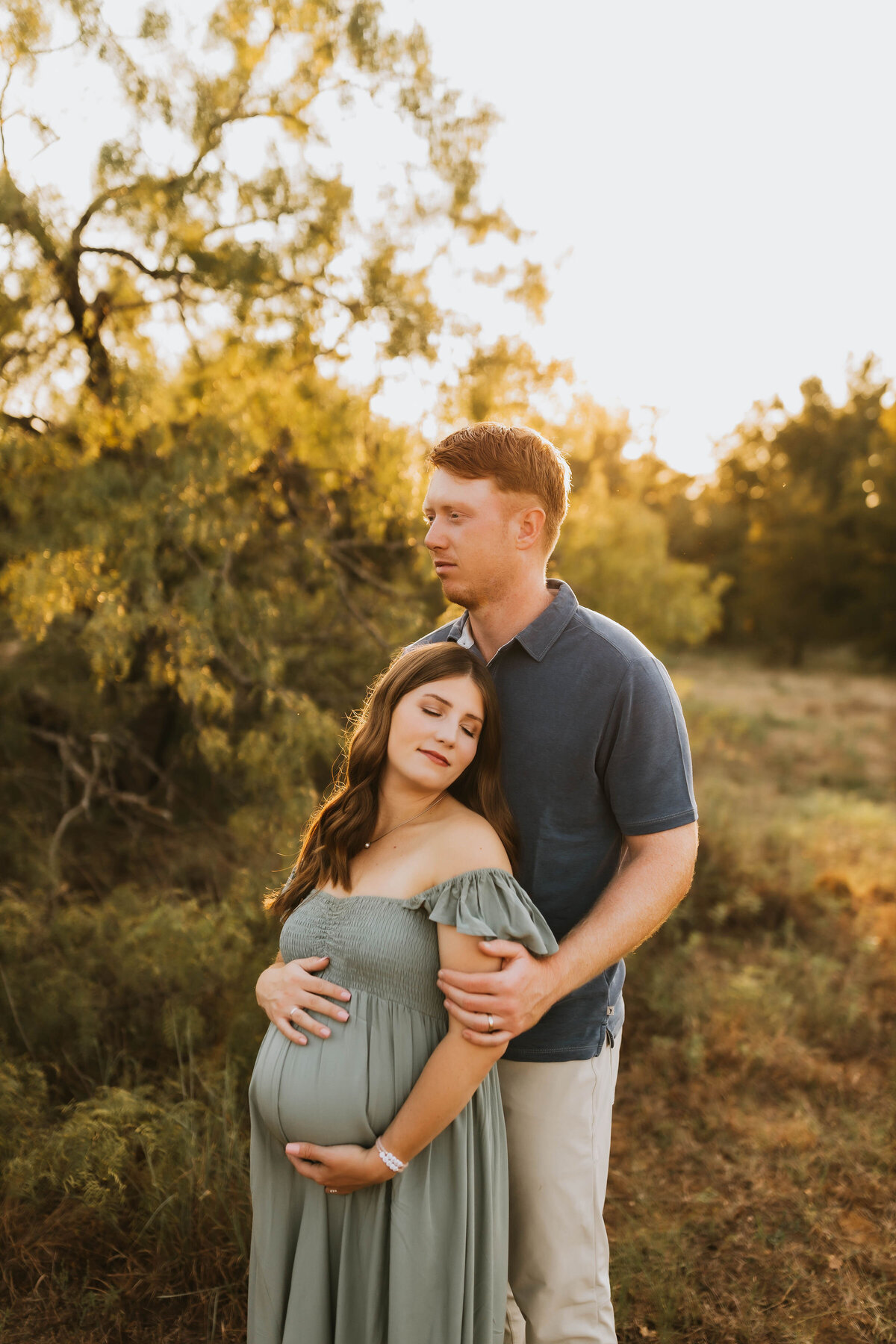 expecting couple embracing