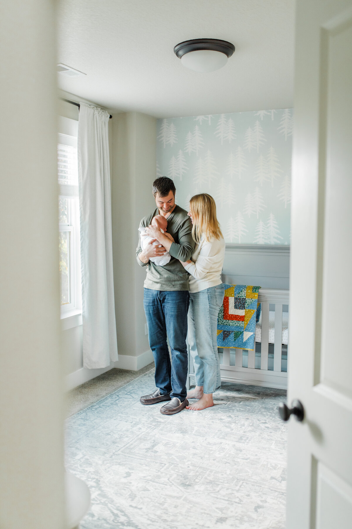Family of three inside the nursery