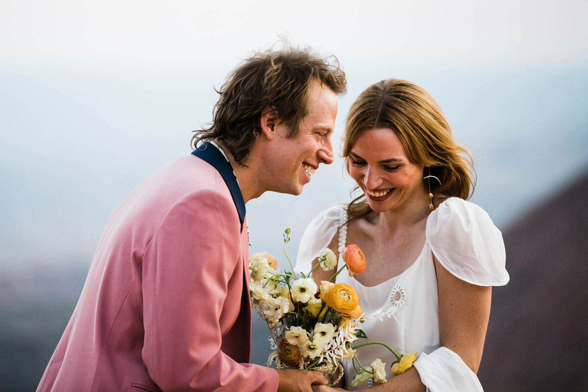 During their arizona elopement the bride plays with the ribbon on her bouquet..