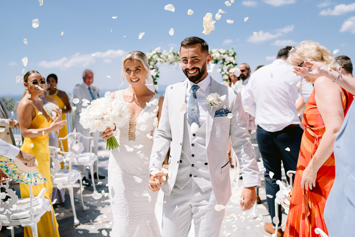 confetti being thrown at a bride and groom at a sorrento wedding