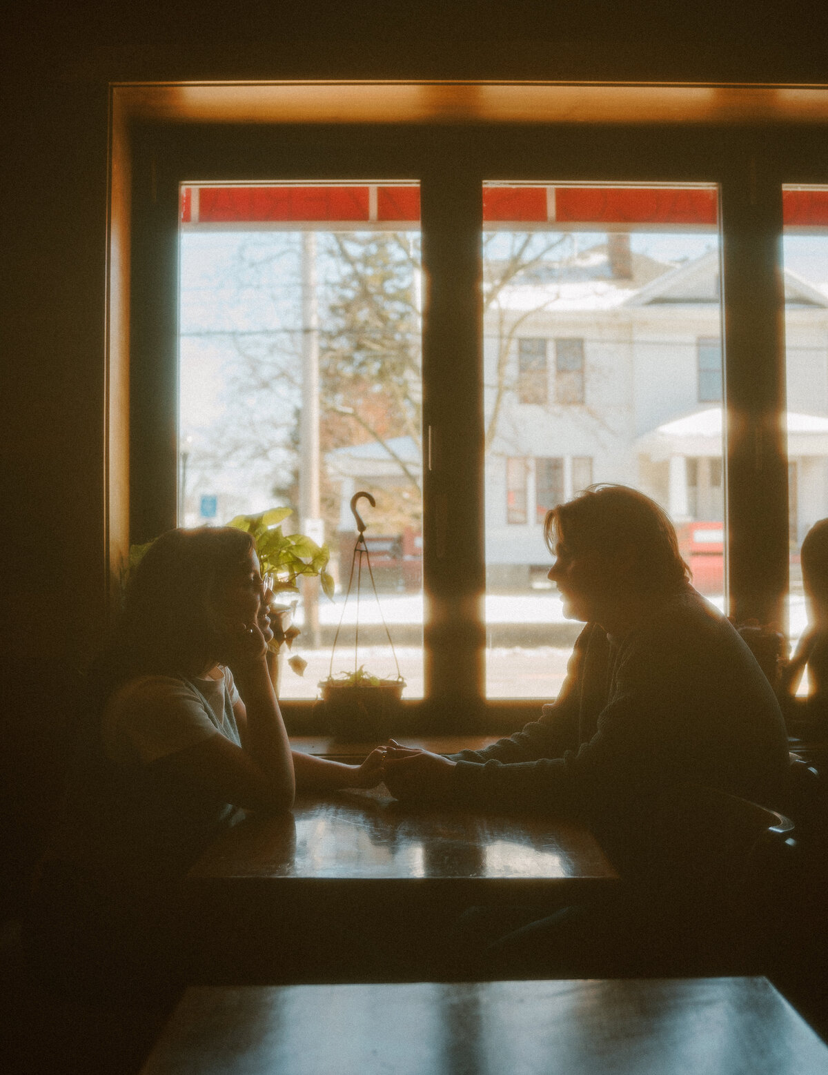 super 8 film photography of couple candidly talking at cafe