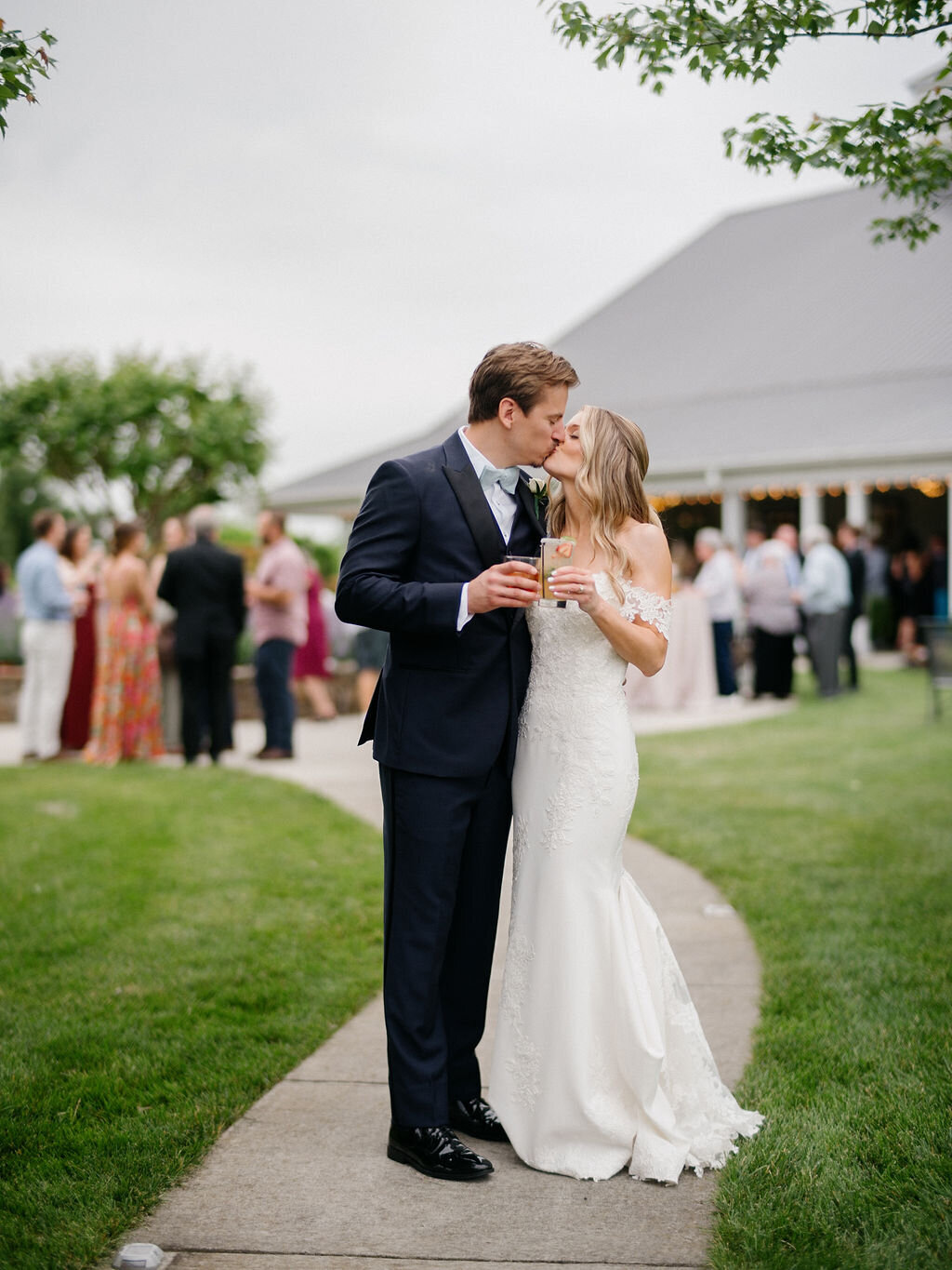 Bride and groom kissing outside of the wedding venue