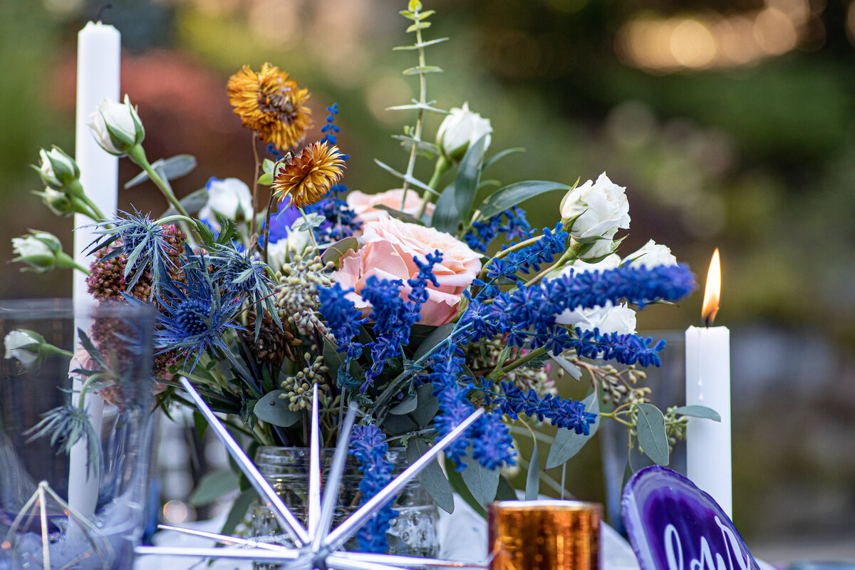 Vibrant floral centerpiece with deep blue and orange accents at co-ed baby shower in Sparta, NJ.