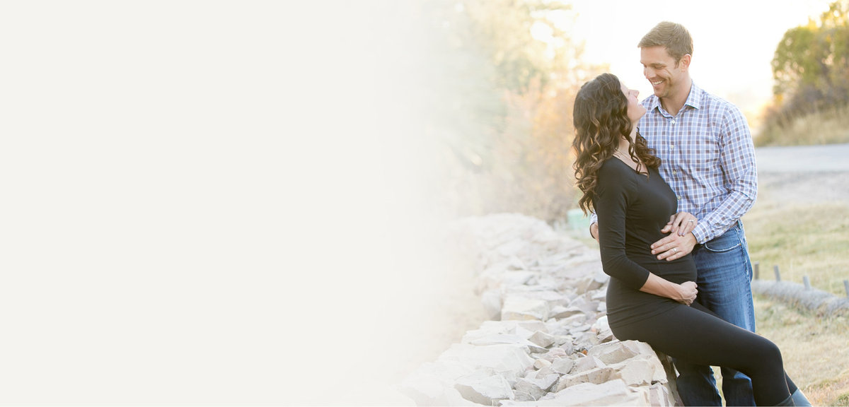 Expecting couple posing for a maternity photograph session in Denver