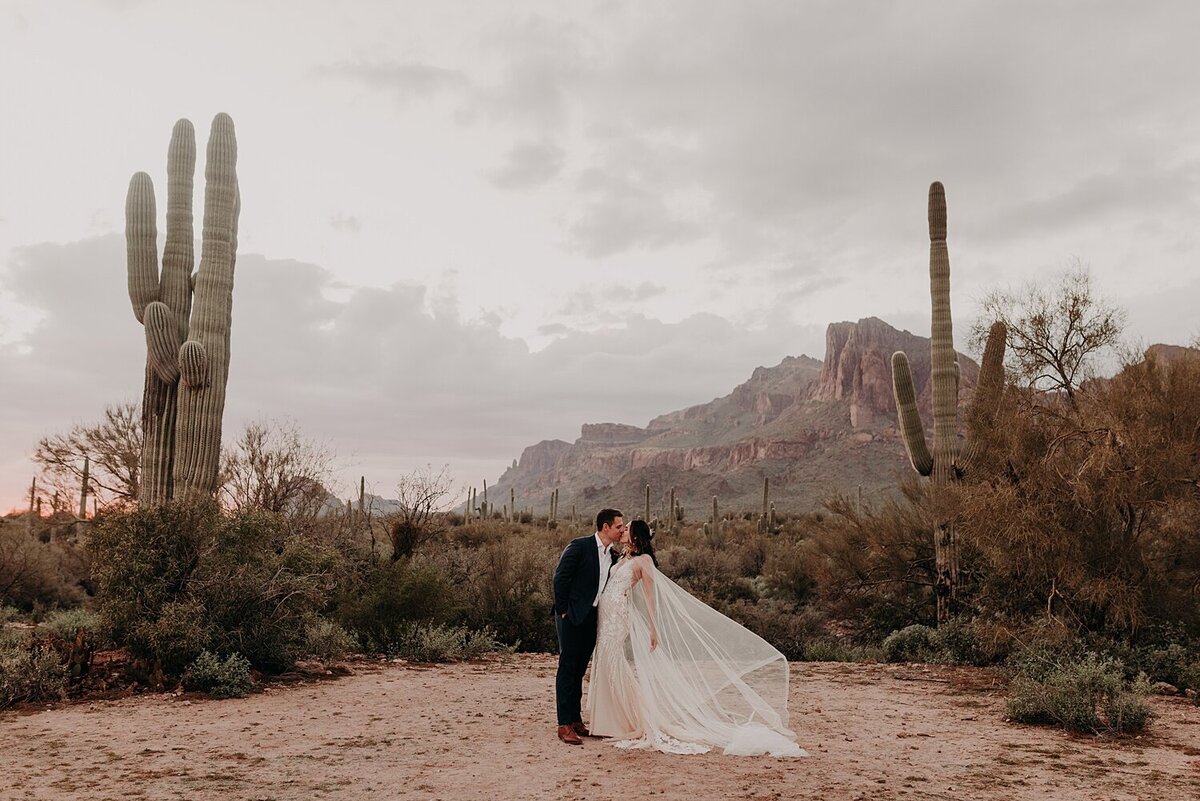 Bride and Groom dramatically kiss in the desert