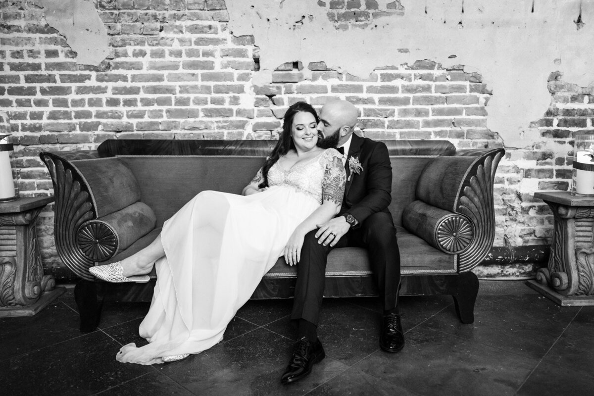 Bride and groom on old couch in Latrobe's
