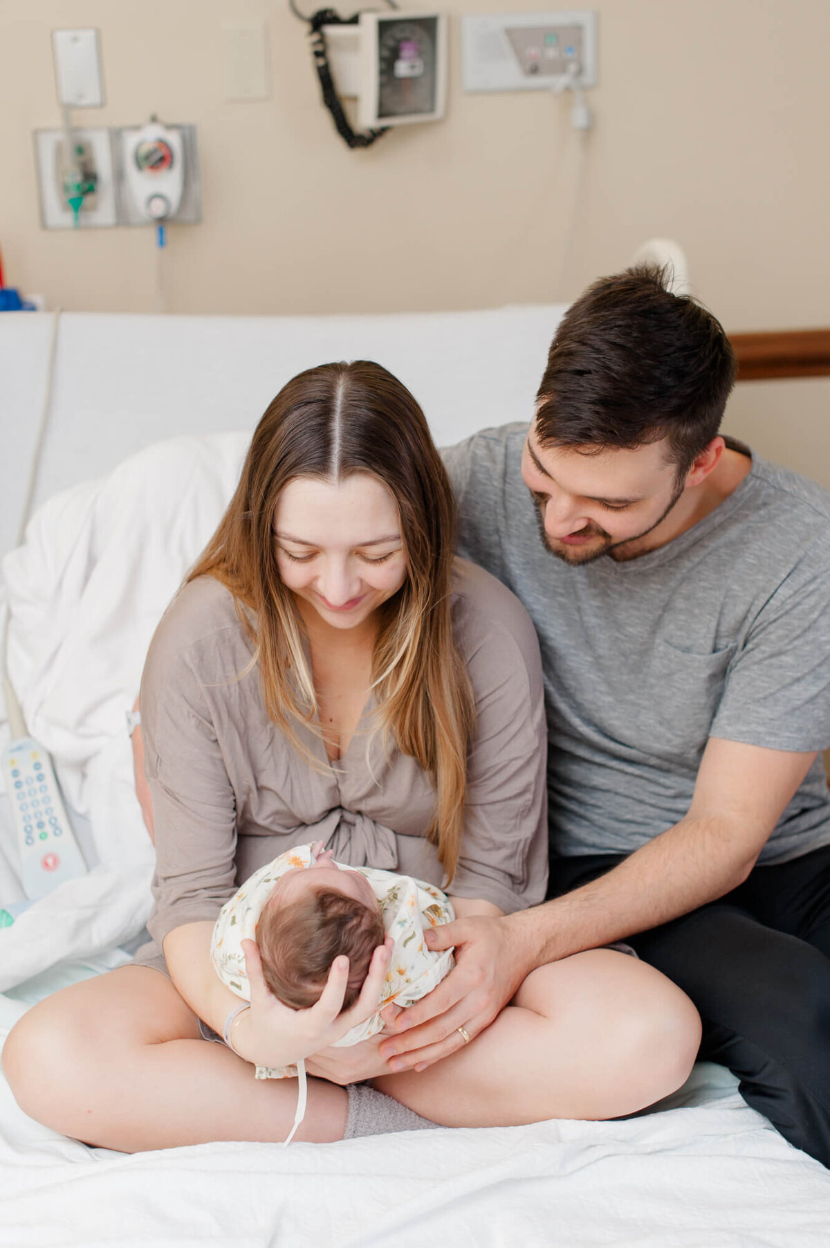 New parents hold their newborn babygirl in the hospital during their Fresh 48 session at Rockledge Regional Medical Center