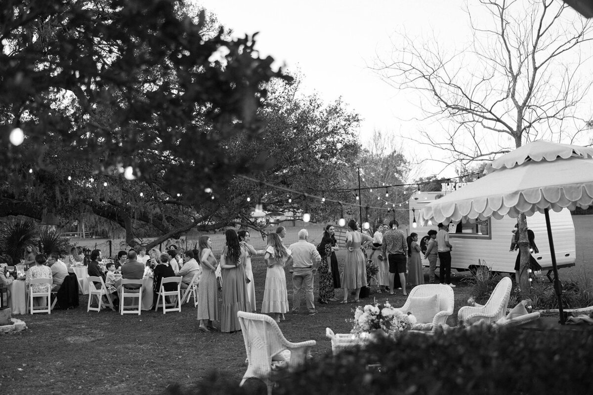 Black and white photo of a wedding ceremony under the oaks at Uliana Estate in Lakeland FL.

