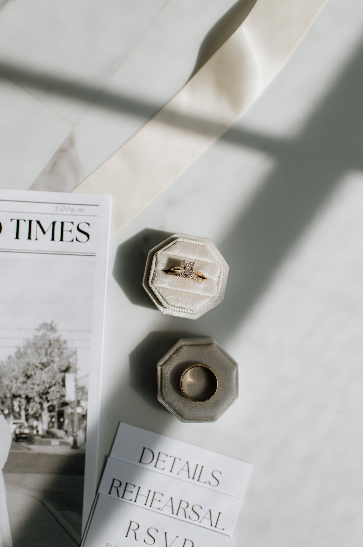 Wedding rings and invitation flat lay photo