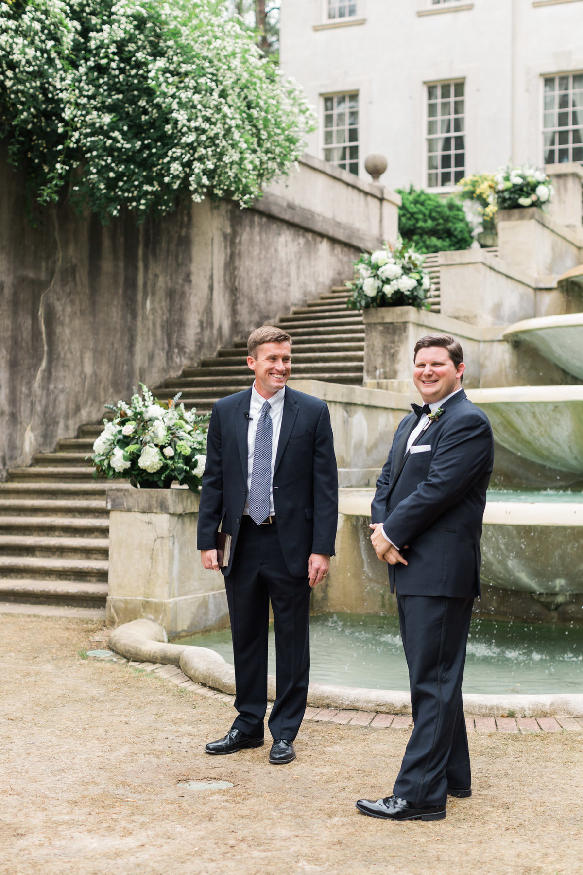 An eager groom awaits his bride moments before his wedding ceremony. Photo by luxury destination wedding photographer Rebecca Cerasani.