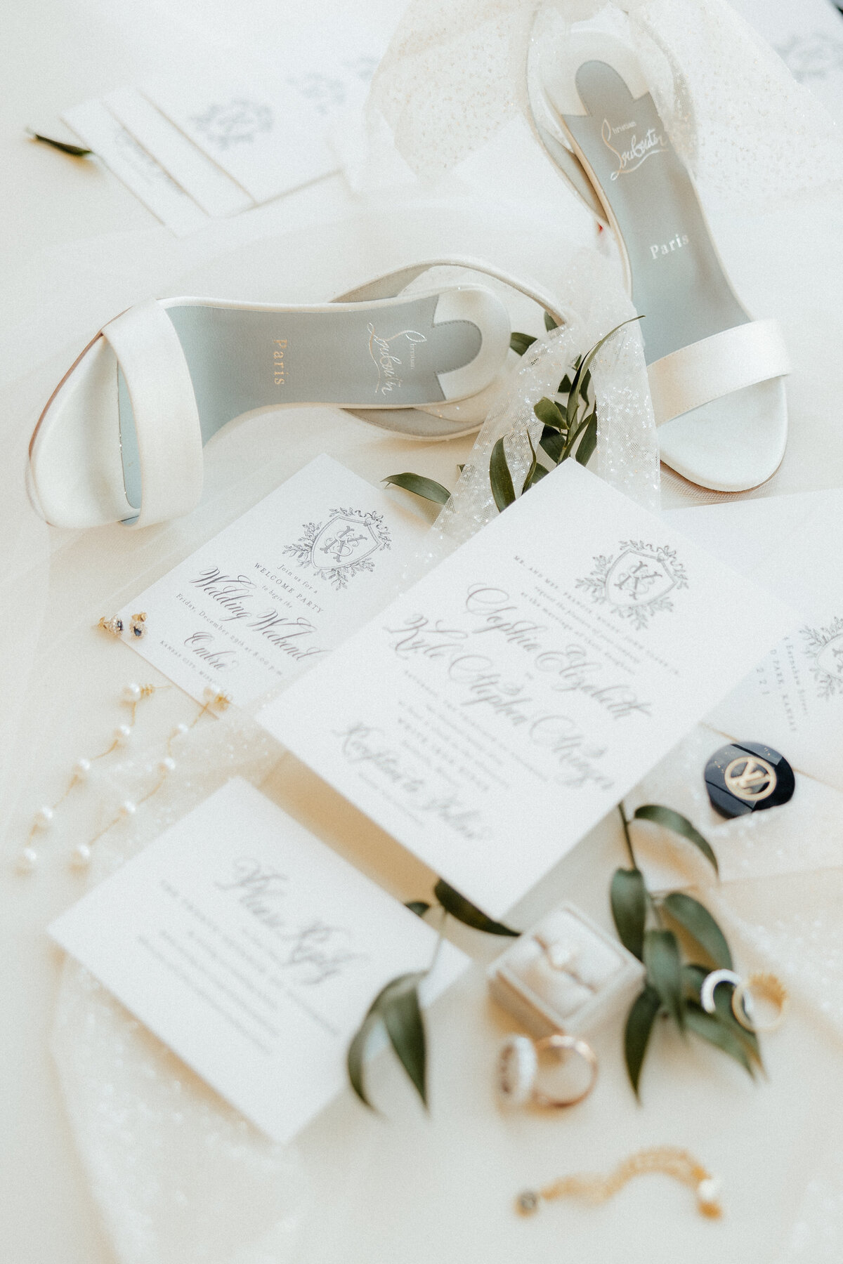 Bridal wedding details, including shoes, invitations, rings, and other jewelry.