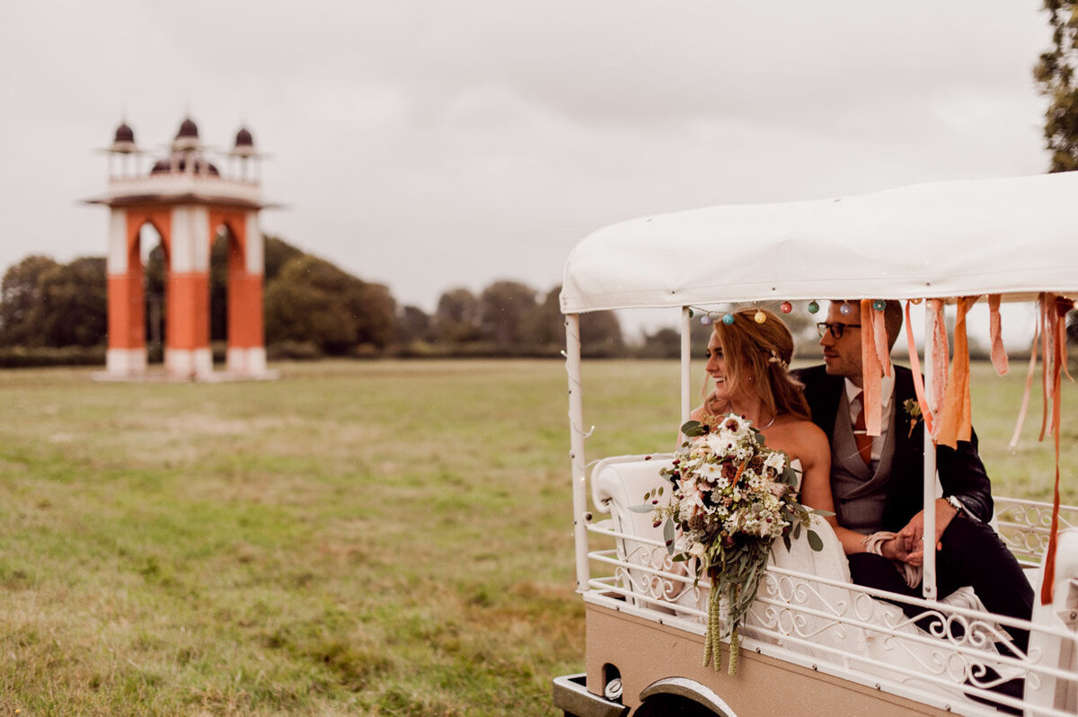 Bride and groom riding in cart