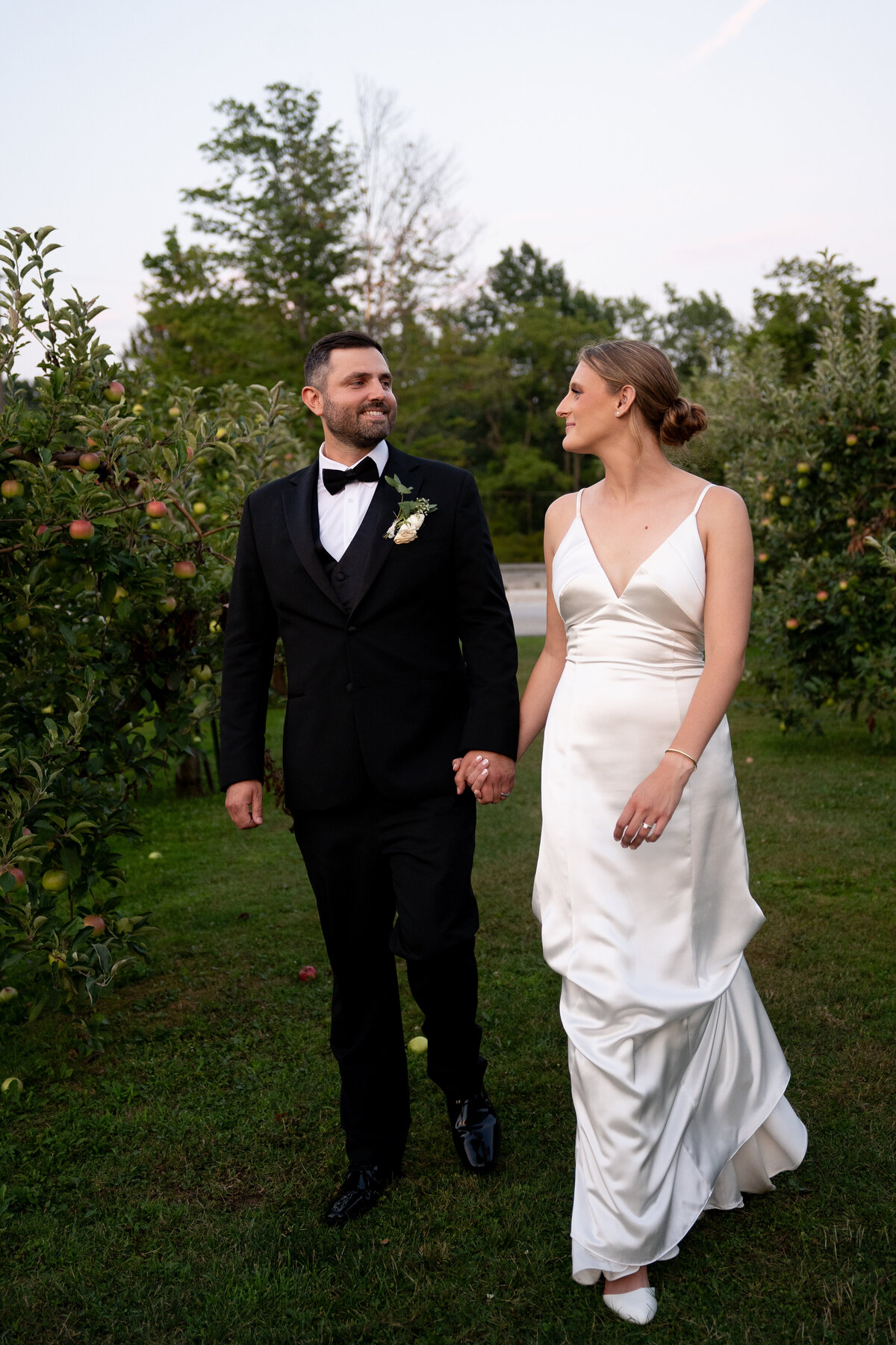 couple walking during blue hour at outdoor wedding at Patterson Fruit Farm
