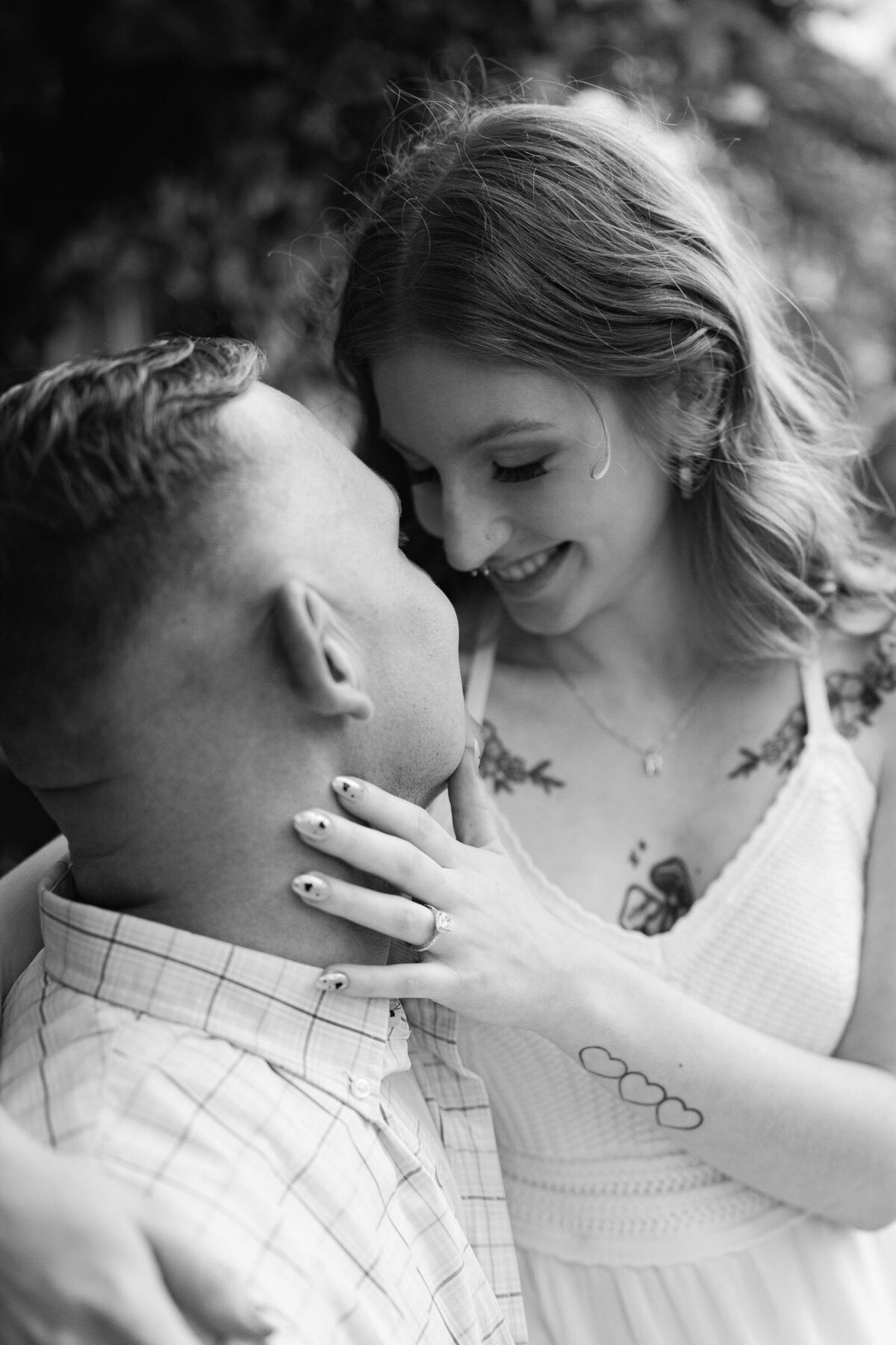 engaged couple embracing and looking at each other