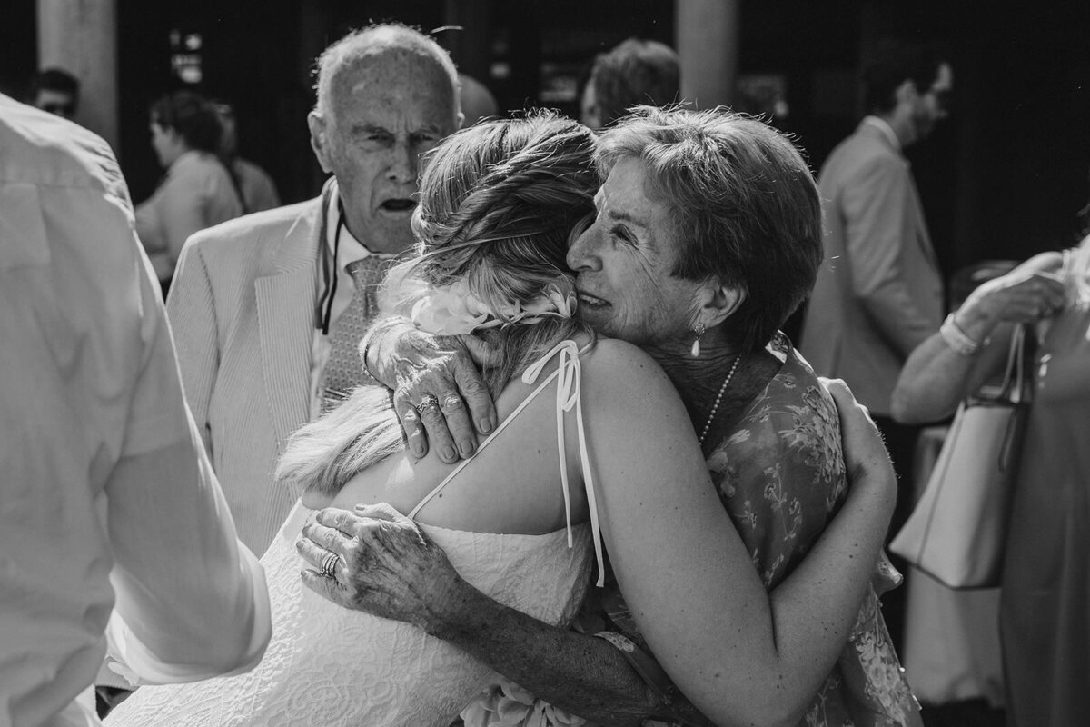 A newlywed hugging a family member 