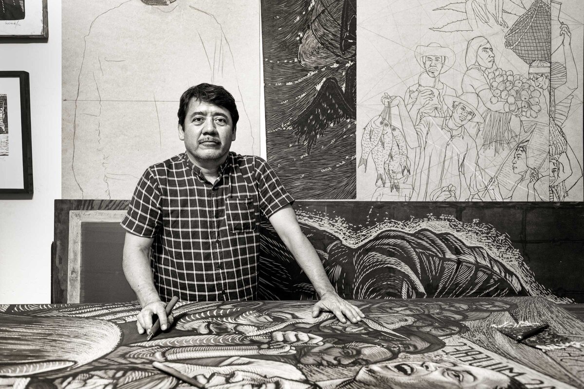 Mario Guzman in Oaxaca, Mexico with wood cared artwork for prints