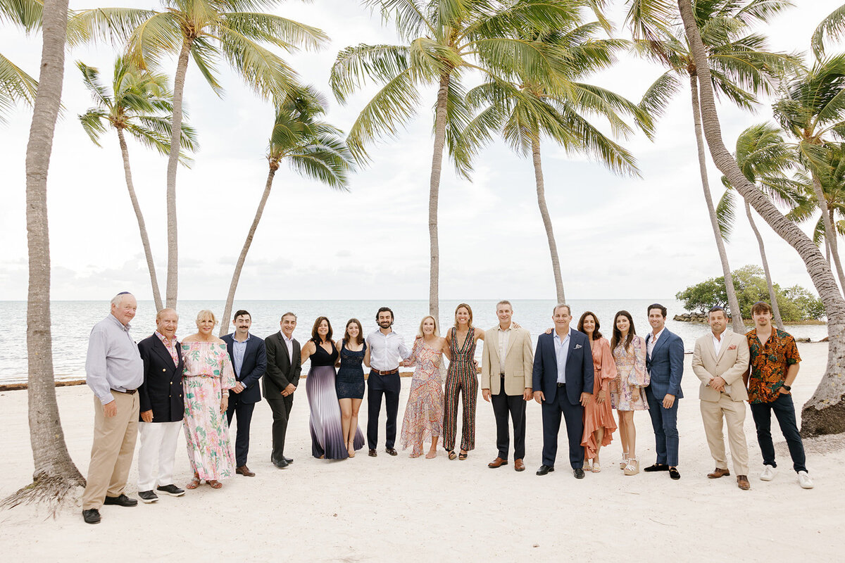 A beautiful group portrait of family and friends celebrating Minette and Evan’s wedding in the Florida Keys. Islamorada wedding photography by Claudia Amalia.