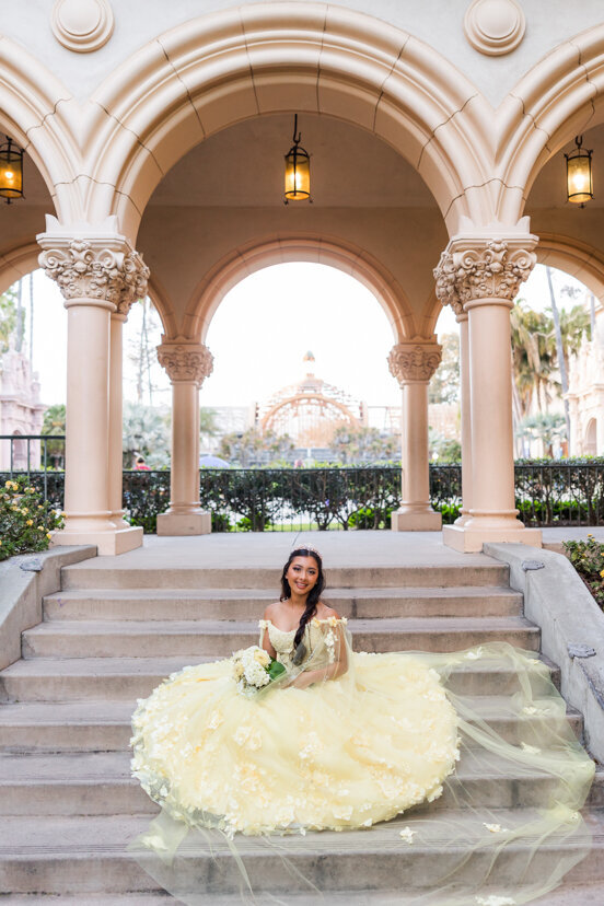 girl-sitting-steps-yellow-dress-quinceanera