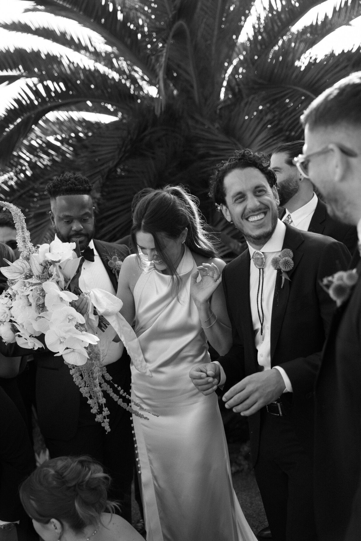 Wedding party enjoying a lively toast together, filled with smiles and cheers at a La Jolla wedding venue in Southern California.