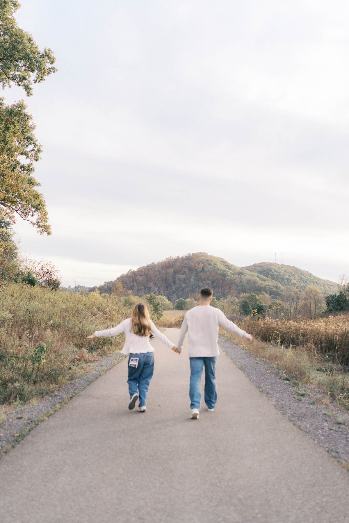 man and woman run at seven islands state birding park in october near knoxville tennessee
