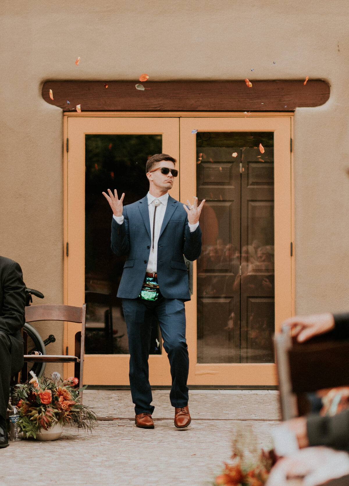 Flower man tossing petals during a wedding ceremony.