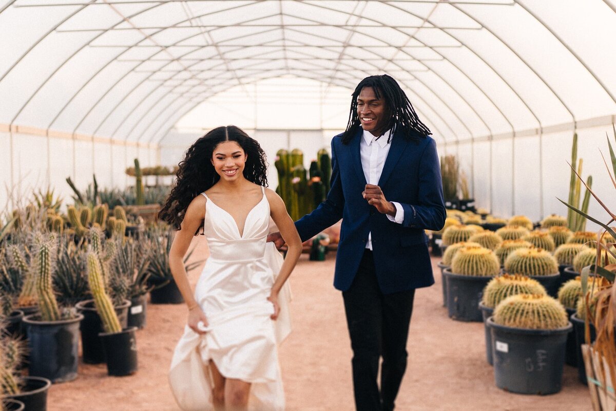 A joyful couple, hand in hand, gleefully running inside a geodome at Cactus Joe's in Las Vegas.