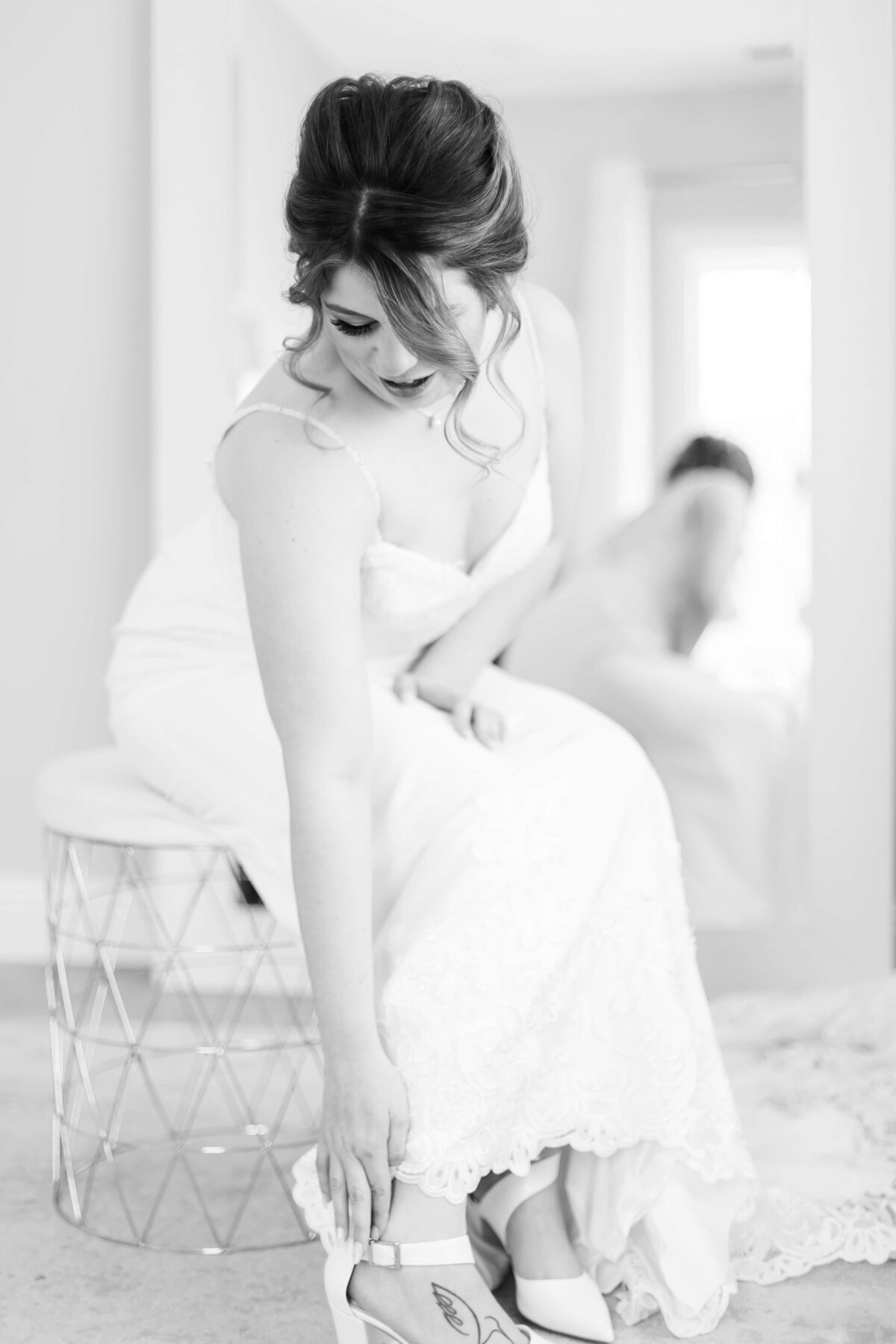 Bride reaching down to tie shoes at Nashville wedding