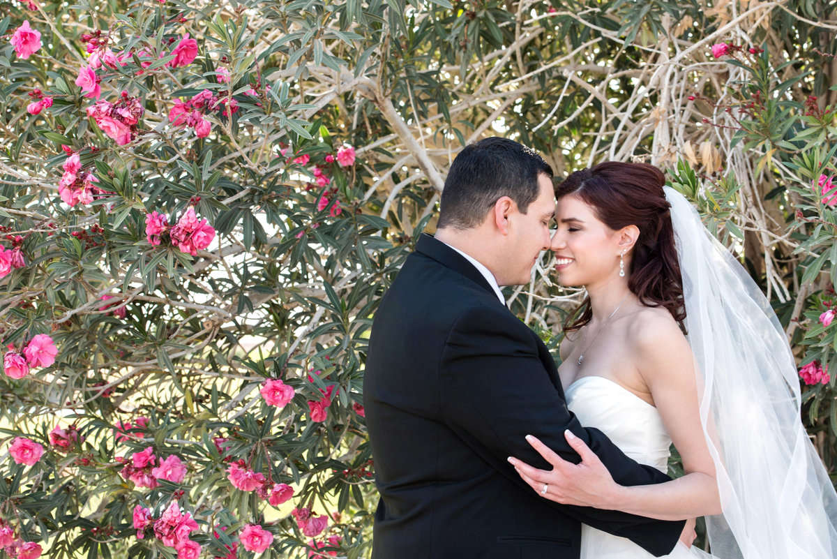 bride and groom in front of bougainvillea