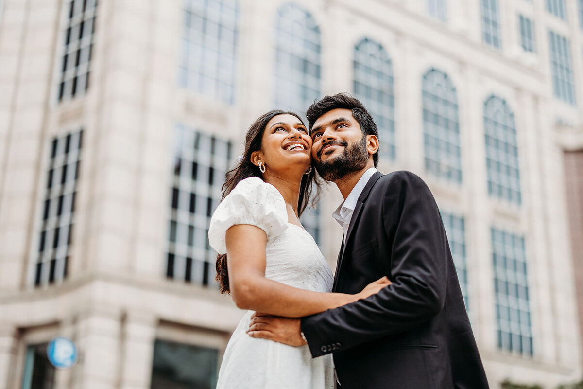 Engaged couple embraces on Boston street