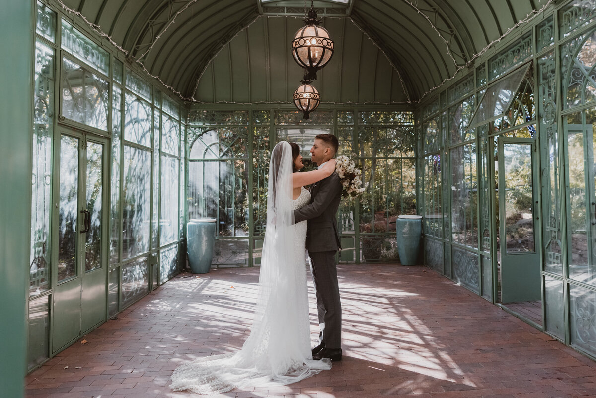 Bride and groom in the greenhouse at the Denver Botanic Gardens.