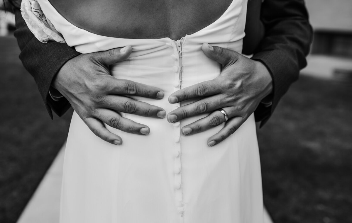 Couples Photographer,  a groom's arms wrap around a bride as they dance