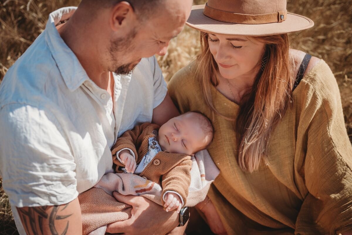 parents looking at newborn baby during their wanaka newborn photoshoot